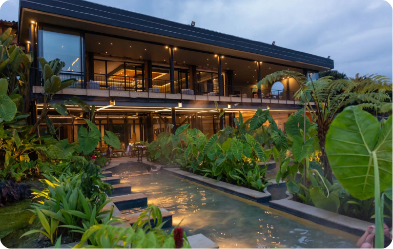 Outdoor thermal pool facing the modern main facade of a hot springs hotel in Manizales.