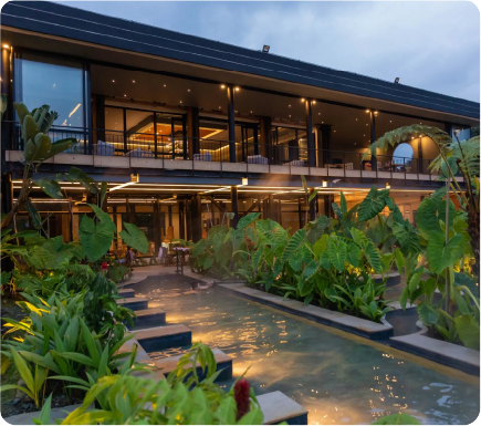 Outdoor facilities and a restaurant illuminated at night at a hot springs hotel in Manizales, Colombia.