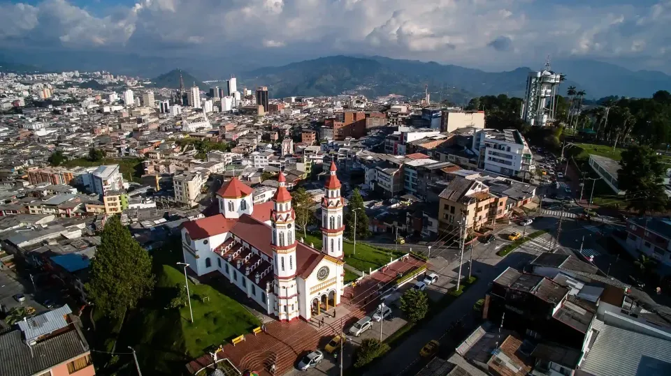 Aerial view of Manizales with iconic church and mountains, a guide to things to do in Colombia’s Coffee Region.