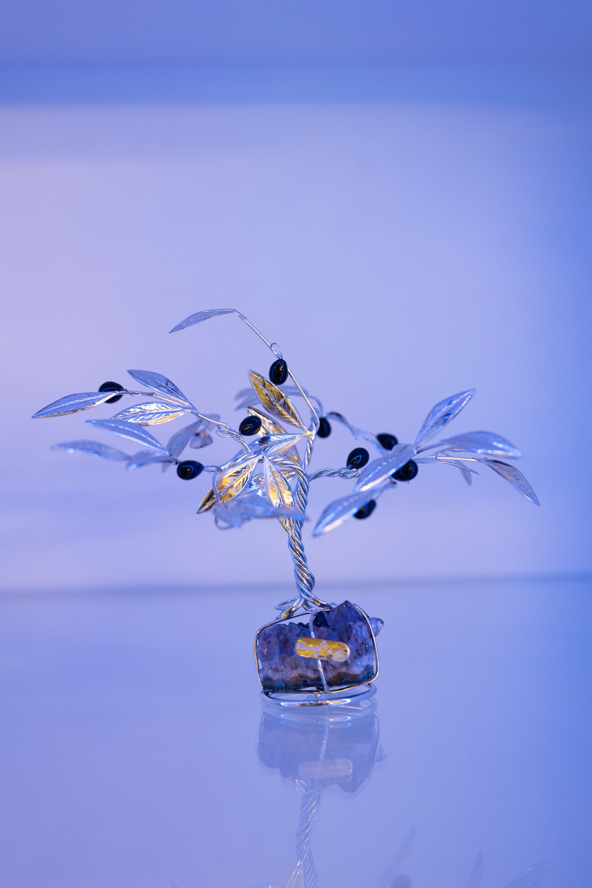 A model airplane is sitting on a tripod on a table in a living room.