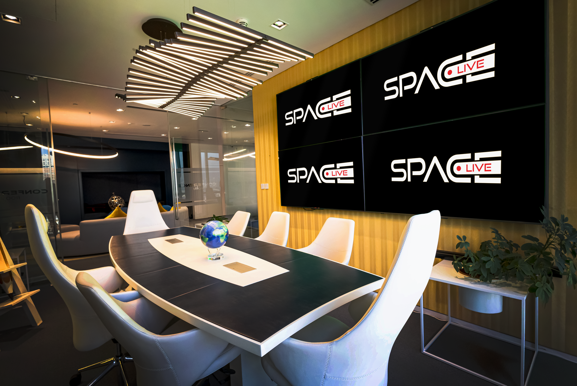 A conference room with a table and chairs and a large screen that says space