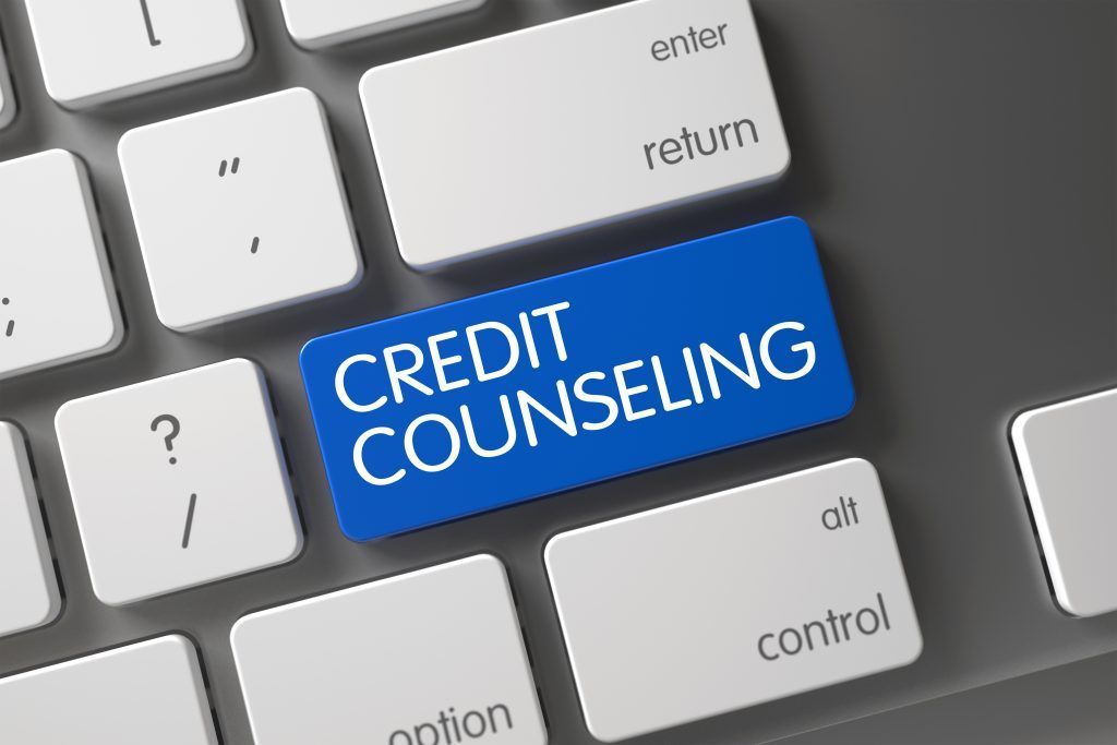 A computer keyboard with a blue button that says credit counseling