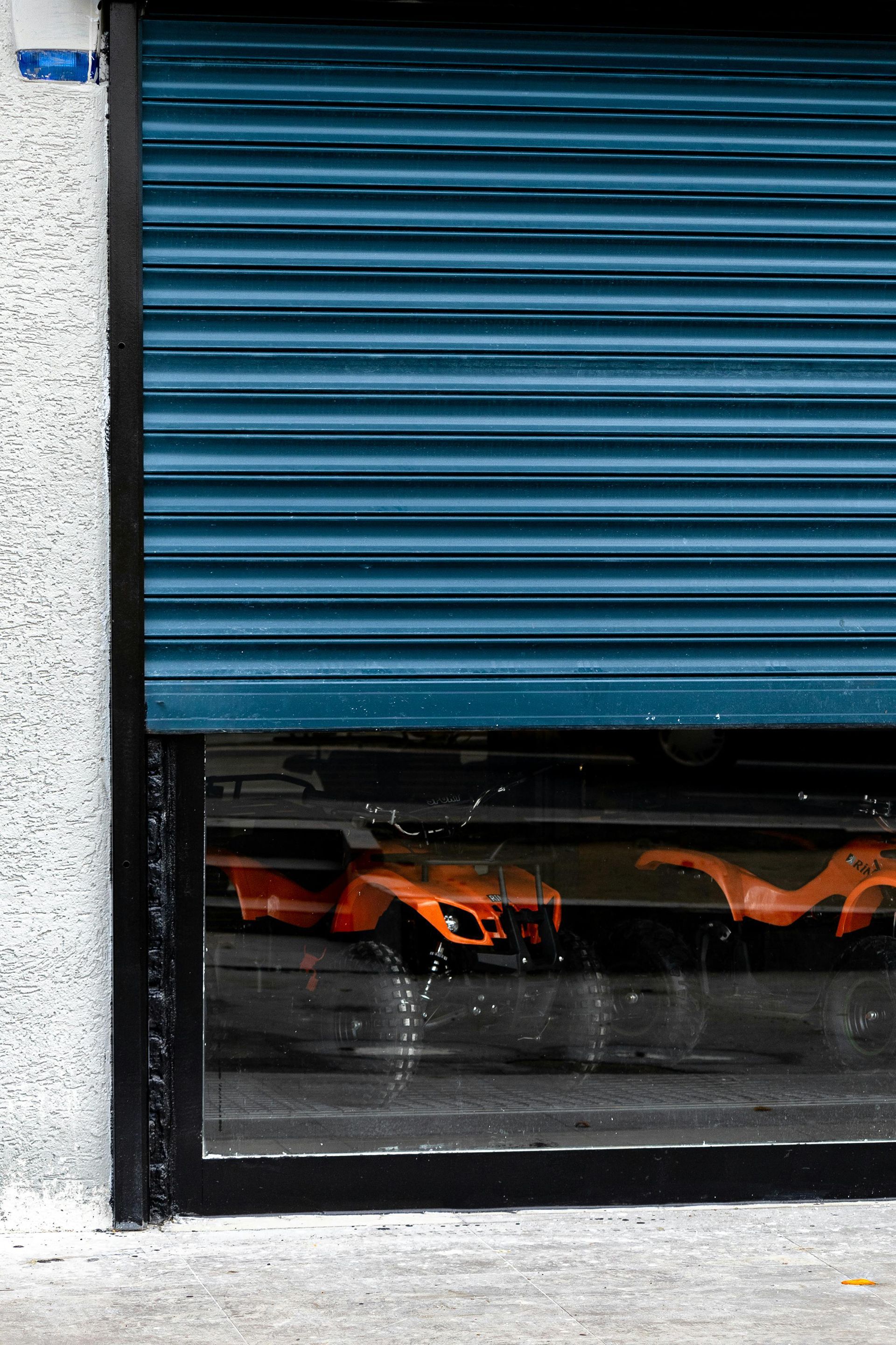 A blue garage door with a fire coming out of it