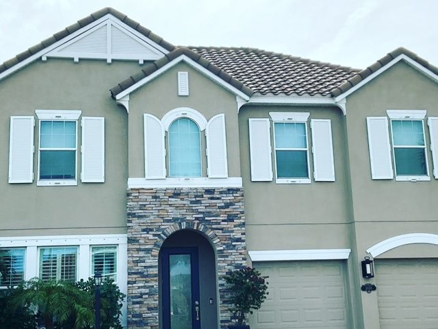A large house with white shutters on the windows