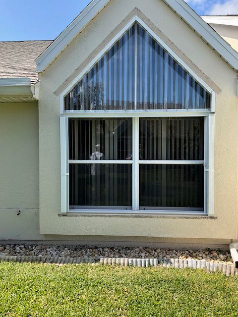 A house with a large window on the side of it