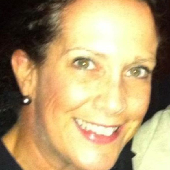 A close up of a woman 's face with a smile on her face