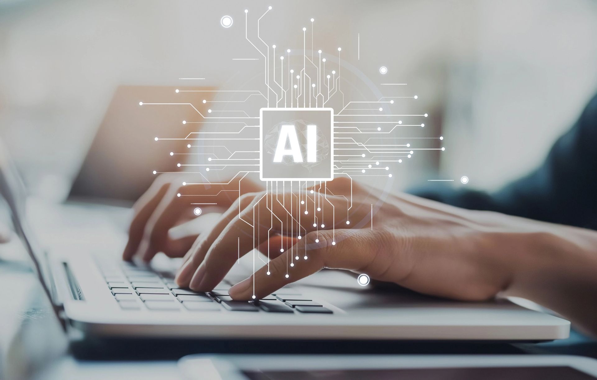 A person is typing on a laptop computer with an ai logo in the background.