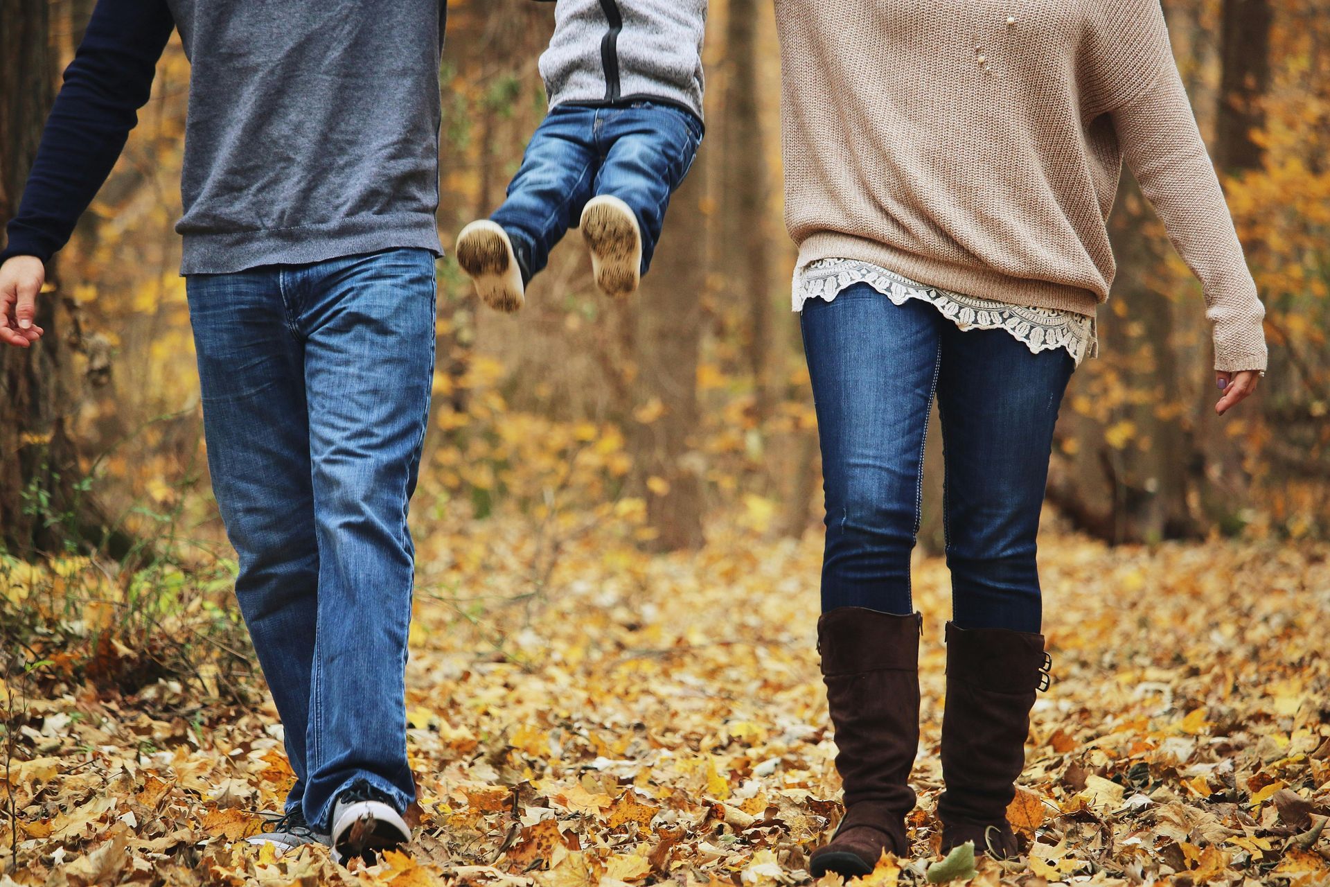 Mother and Father Swinging Their Child