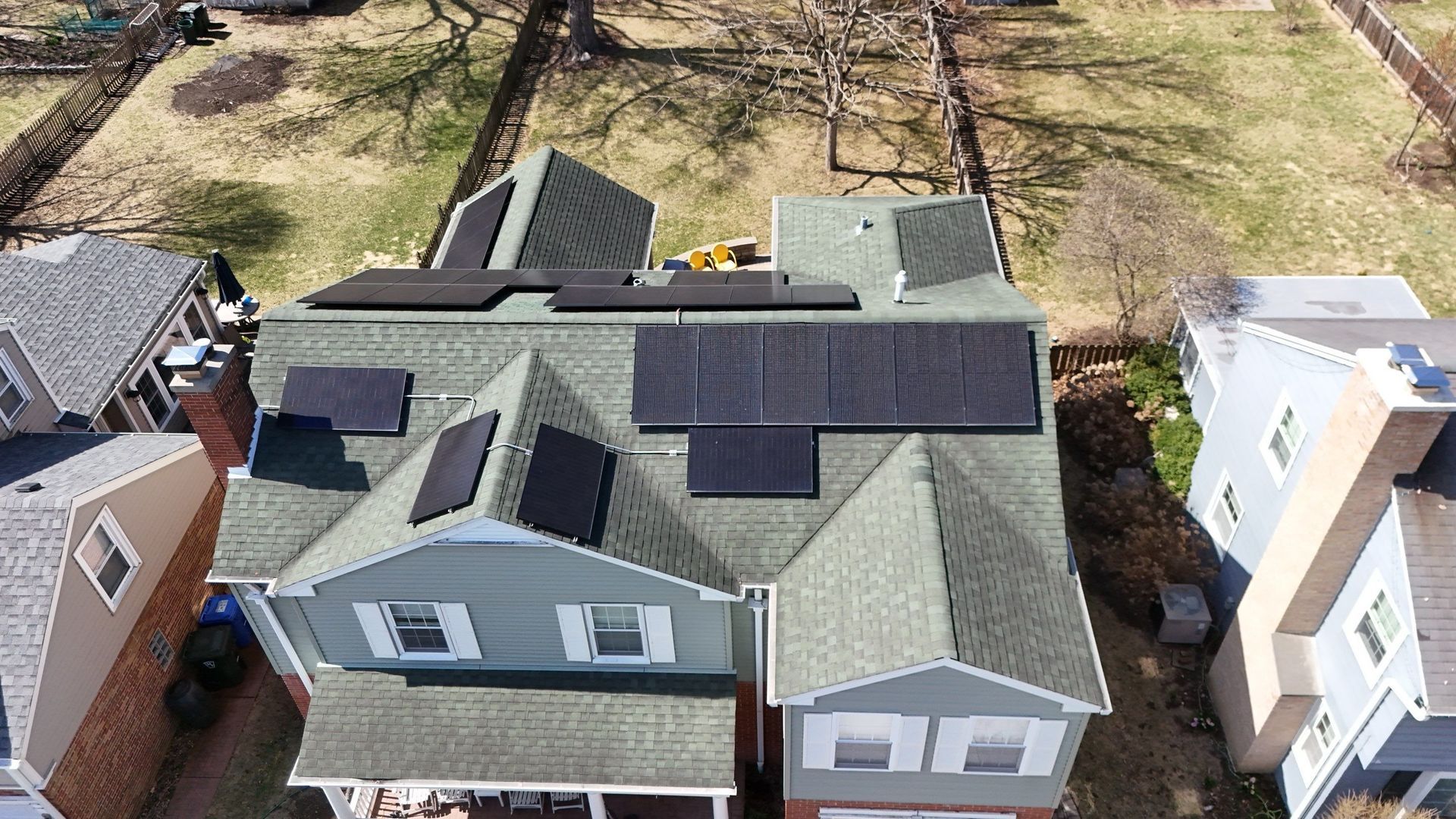 Overhead view of a house with solar panels installed on its roof.