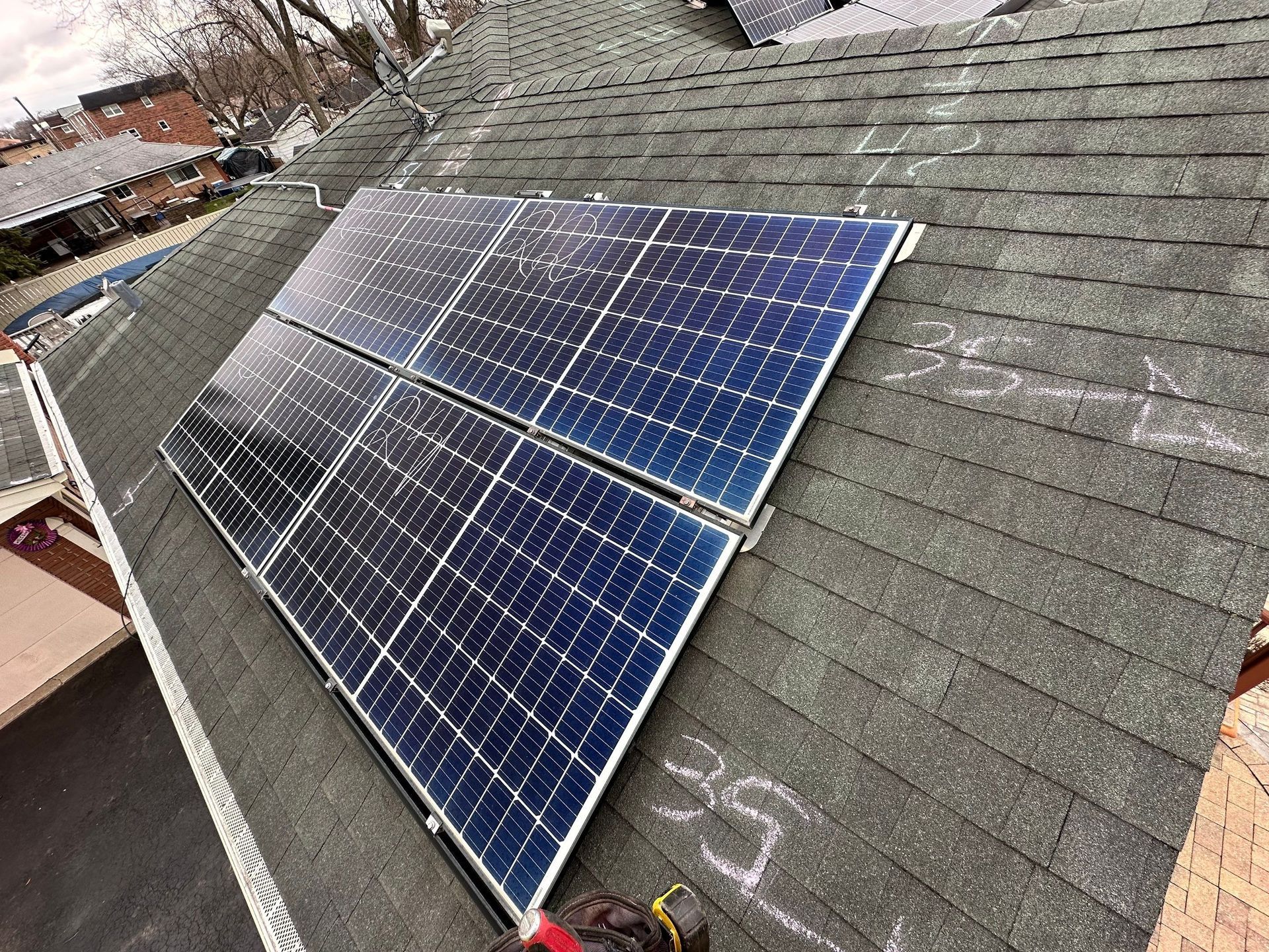 Solar panels installed on a dark asphalt shingle roof.