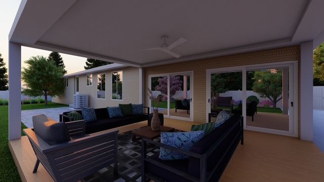 A patio with a tree in the middle of it in front of a house.