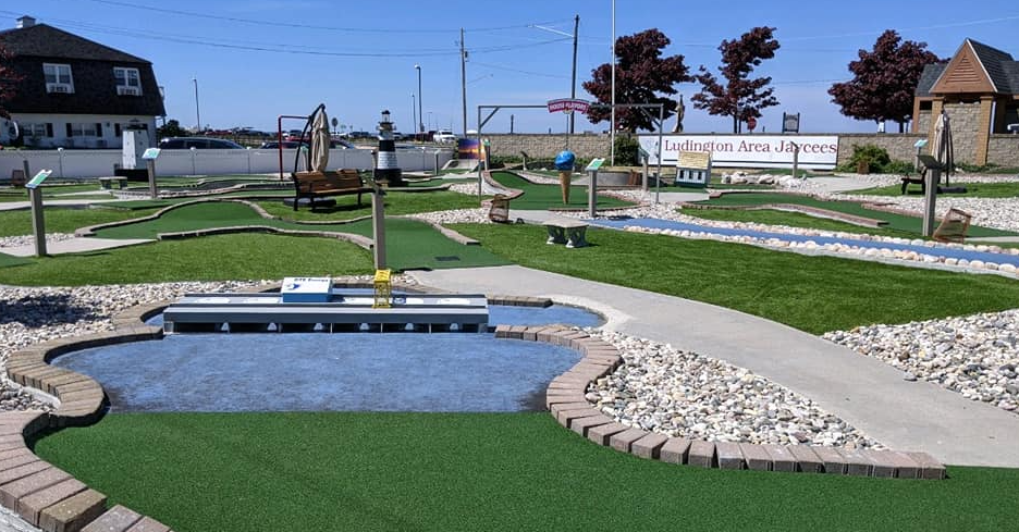 A miniature golf course with a small pond in the middle