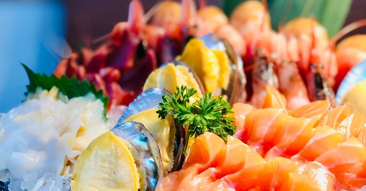 A close up of a plate of seafood on ice.