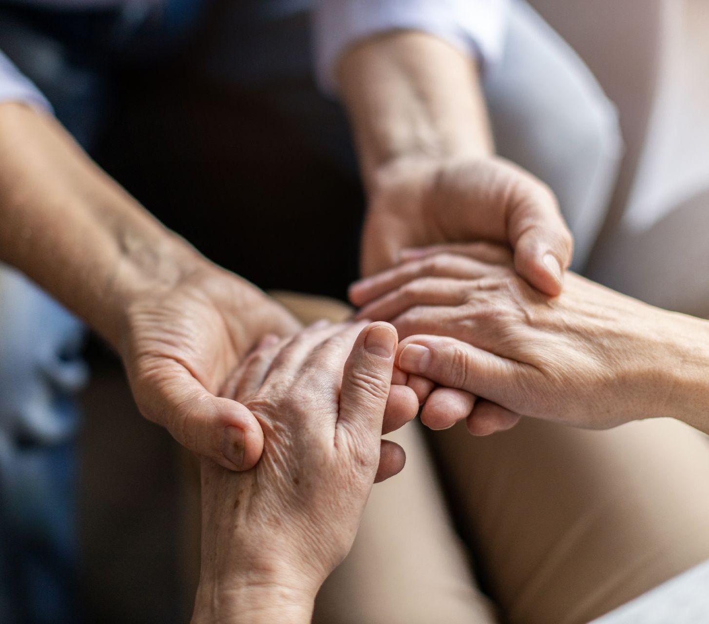A close up of two people holding hands.
