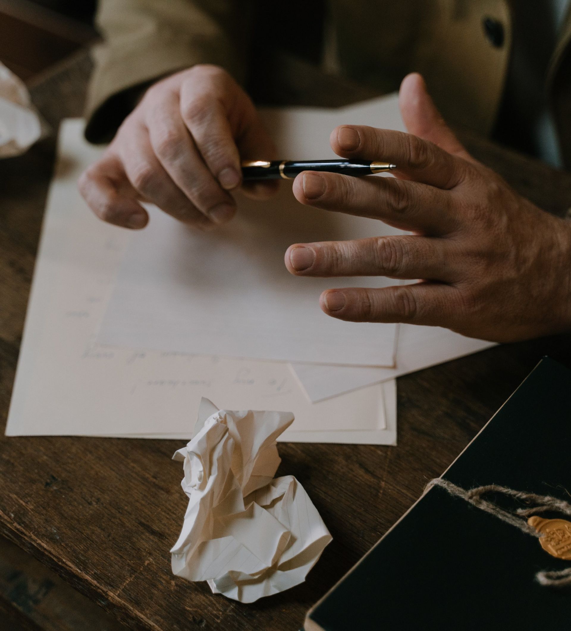 A person is writing on a piece of paper with a pen