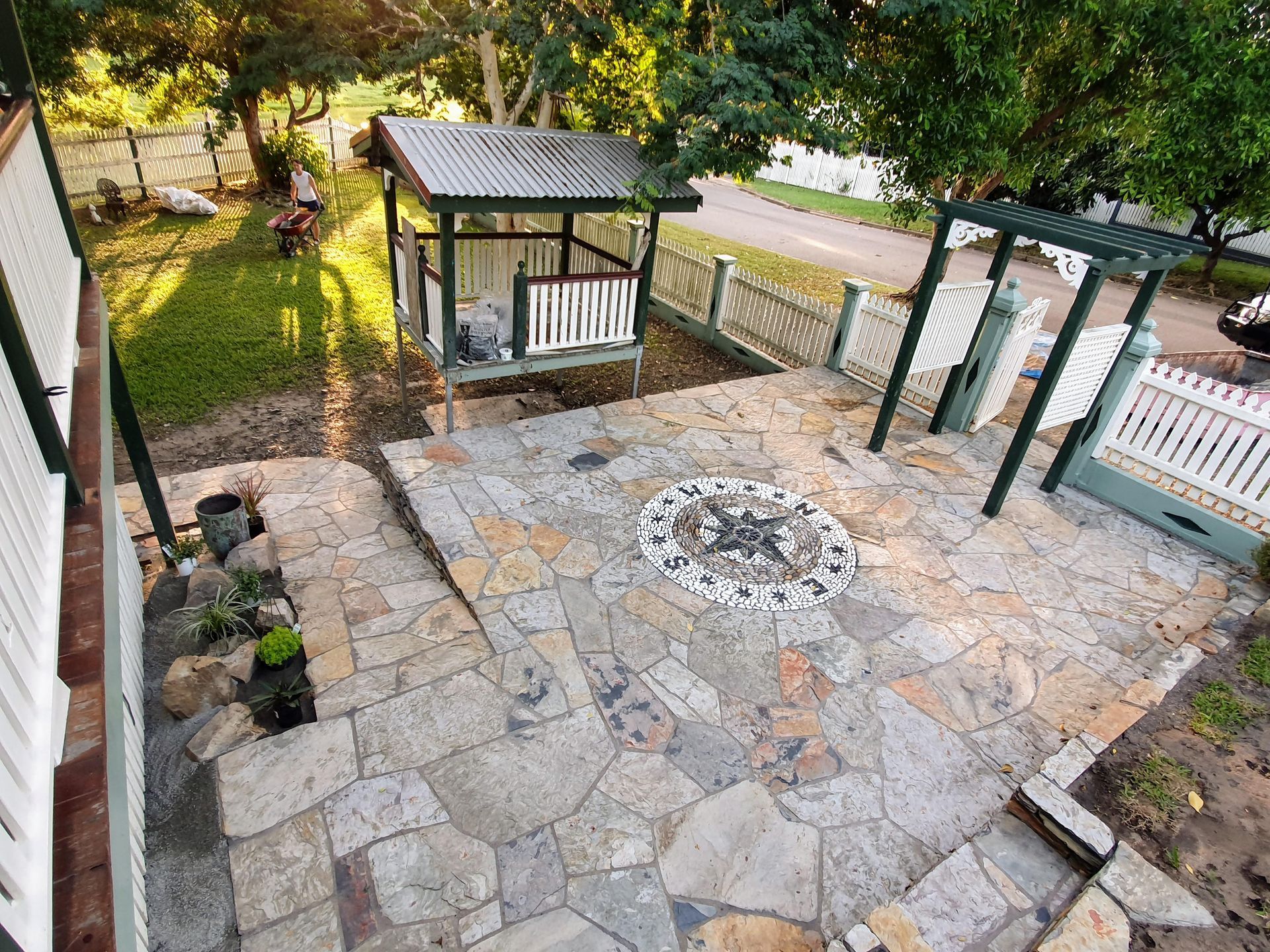 A Stone-paved Patio With a Compass Mosaic — High End Stone Masons in West End, QLD