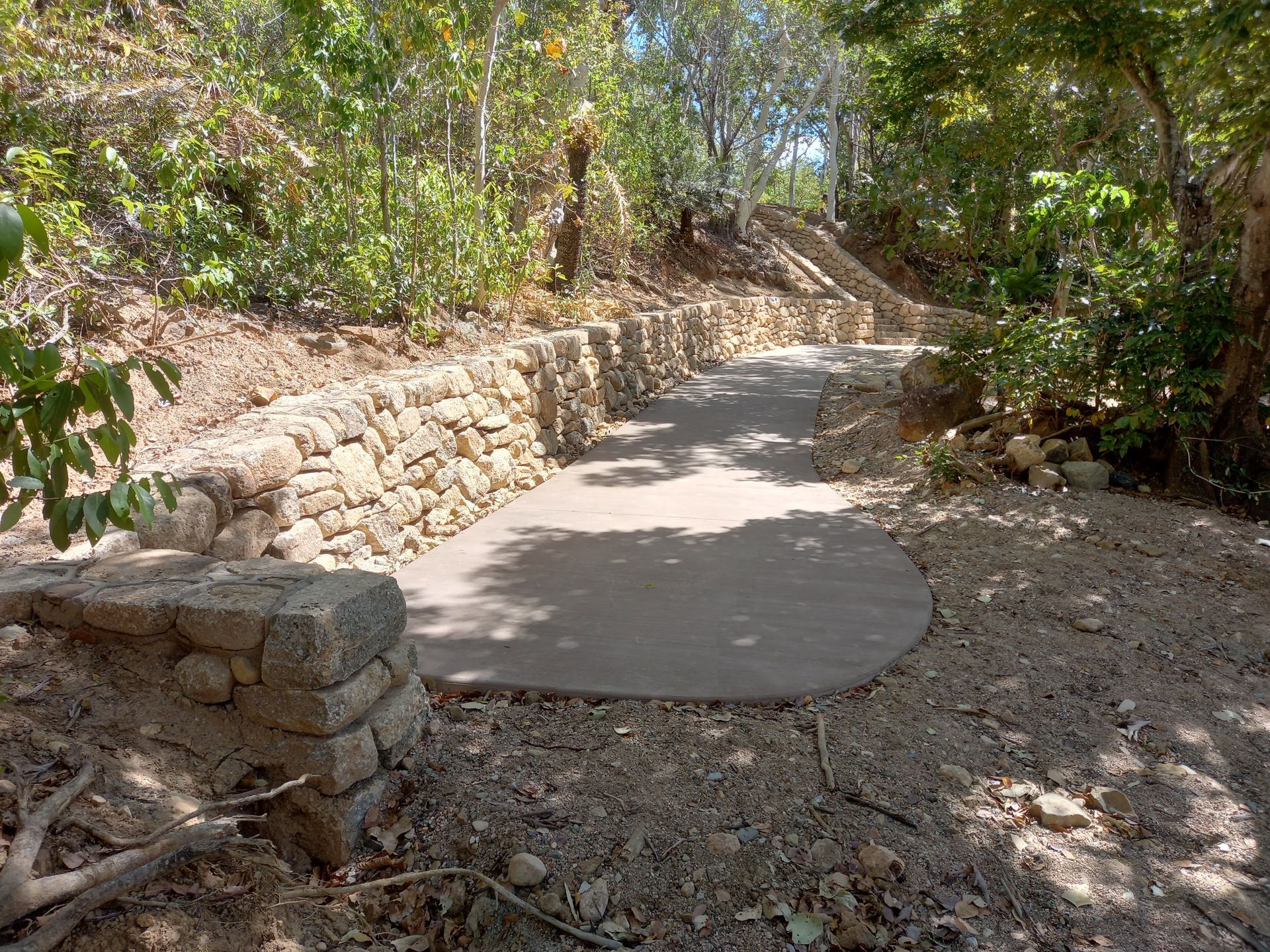A Paved Path Winds Through a Wooded Area — High End Stone Masons in West End, QLD