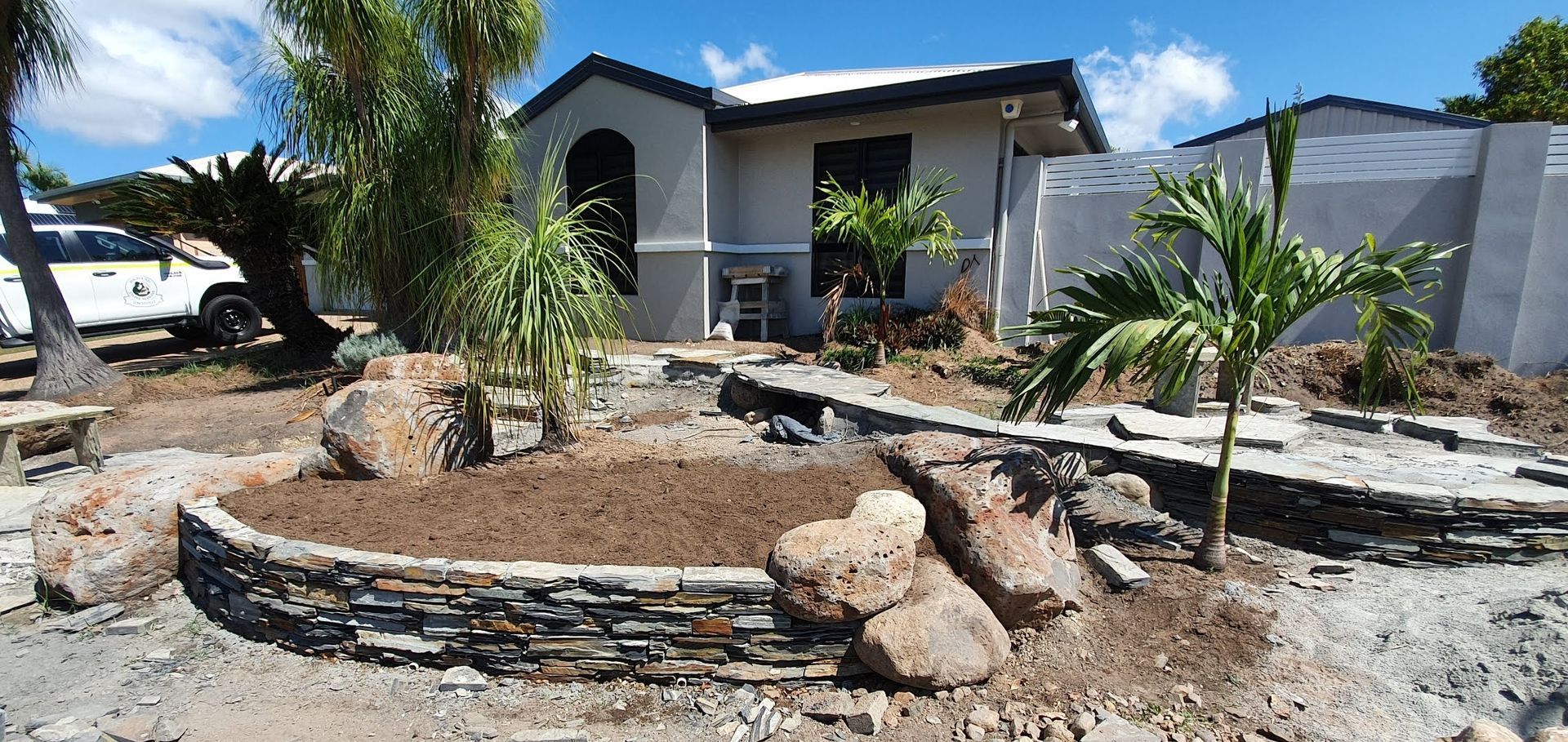 A Front Yard Under Construction Featuring a Newly Built Stone-walled Planter — High End Stone Masons in West End, QLD