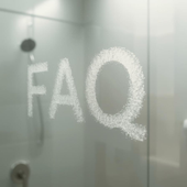 Frosted glass shower door with the letters “FAO” written in condensation
