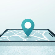 Teal map pin on a folded road map, symbolizing location or navigation