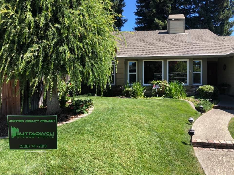 A house with a green lawn, sidewalk, and sign that reads “Kittacavoli Maintenance”.