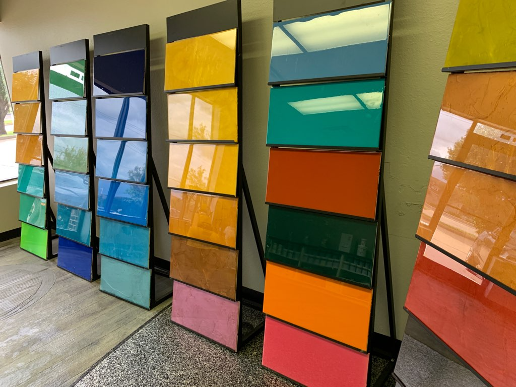 Colorful geometric wall panels arranged in rows along an indoor corridor.