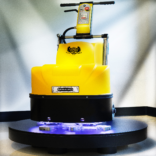 Yellow industrial machine with black base and purple-lit underside on a showroom platform