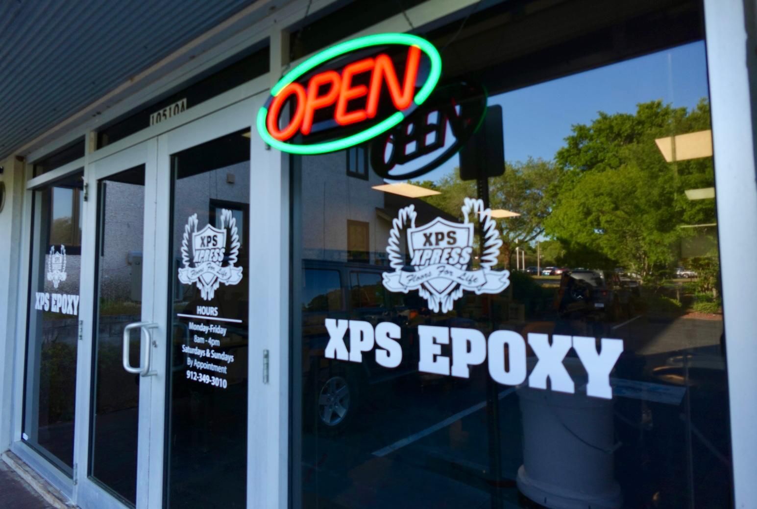 XPS Epoxy storefront with glowing OPEN sign and white lettering on glass doors