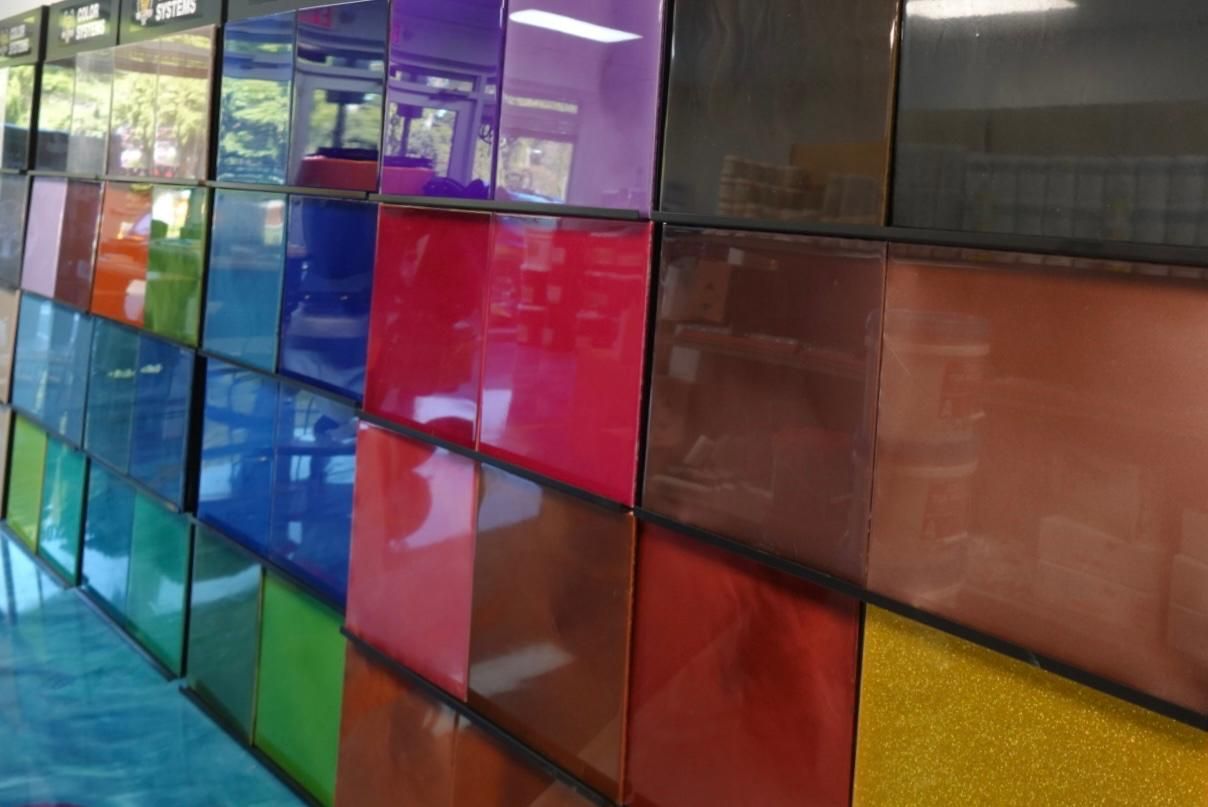 Colorful glass wall panels in purple, blue, red, brown, and yellow tones indoors