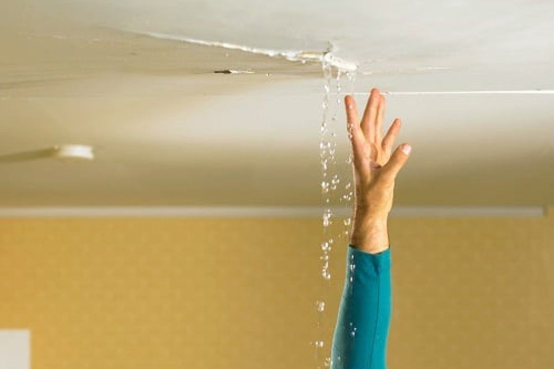 Visible water damage and ceiling stains caused by a leaky residential roof needing repair.