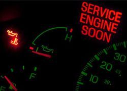 A dashboard on a car with lights on to service the engine at Elis Garage in Malden, MA