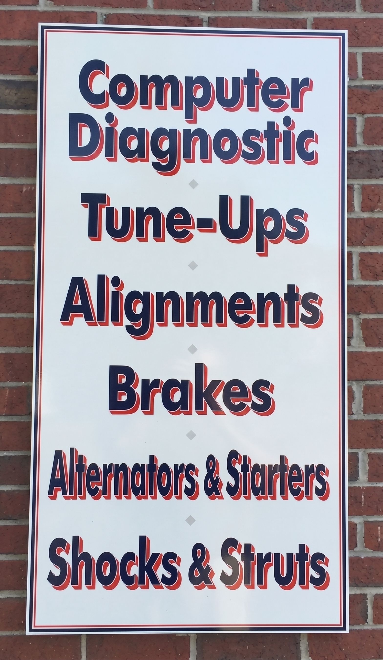 Sign showing services at Elis Garage in Malden, MA, including Tune-ups