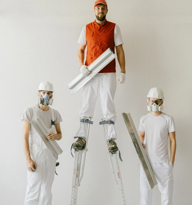 Drywall construction team with blueprints.