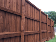 Picture of a brown stained fence.