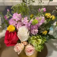 Colorful mixed flower bouquet in a vase with pink, white, yellow, red, and purple blooms