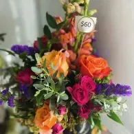 Colorful bouquet of orange, pink, and purple flowers with a $60 price tag