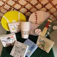 Assorted packaged golf items on display, including balls, tees, and accessories in a basket.