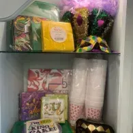 Shelf of colorful gift baskets and wrapped presents in a cabinet