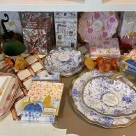 Gift table with blue-and-white china, wrapped presents, and decorative stationery on a shelf