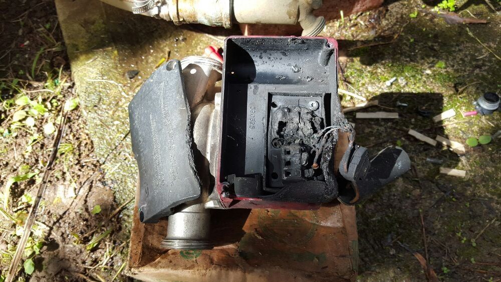 A broken piece of metal is sitting on top of a cardboard box. A broken piece of metal is sitting on top of a cardboard box.