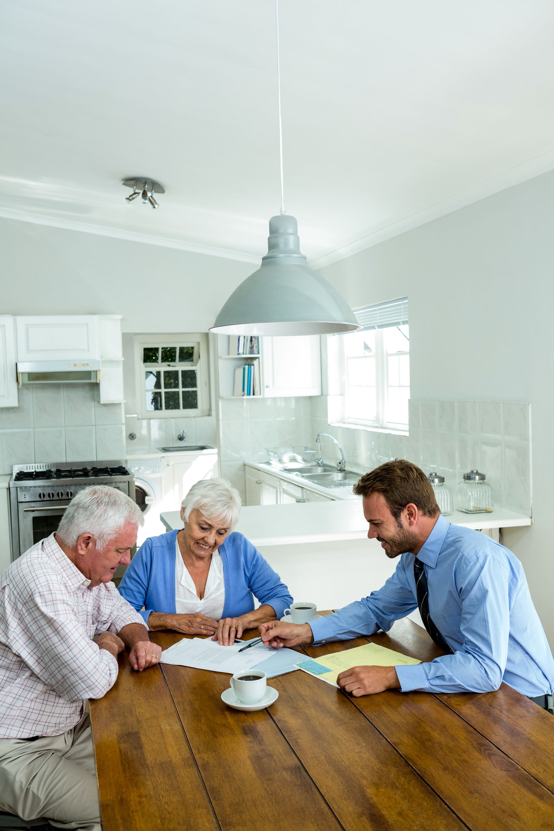 A man and a woman are sitting at a table looking at papers.