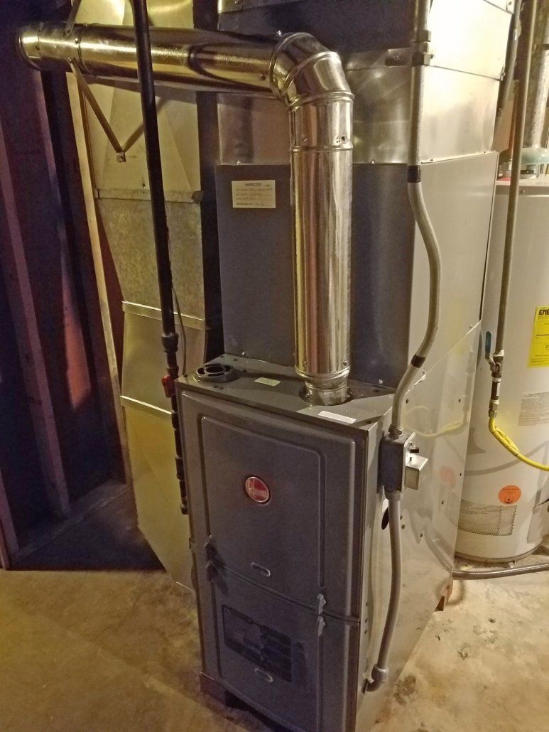 Metal furnace with connected ductwork in a basement utility room