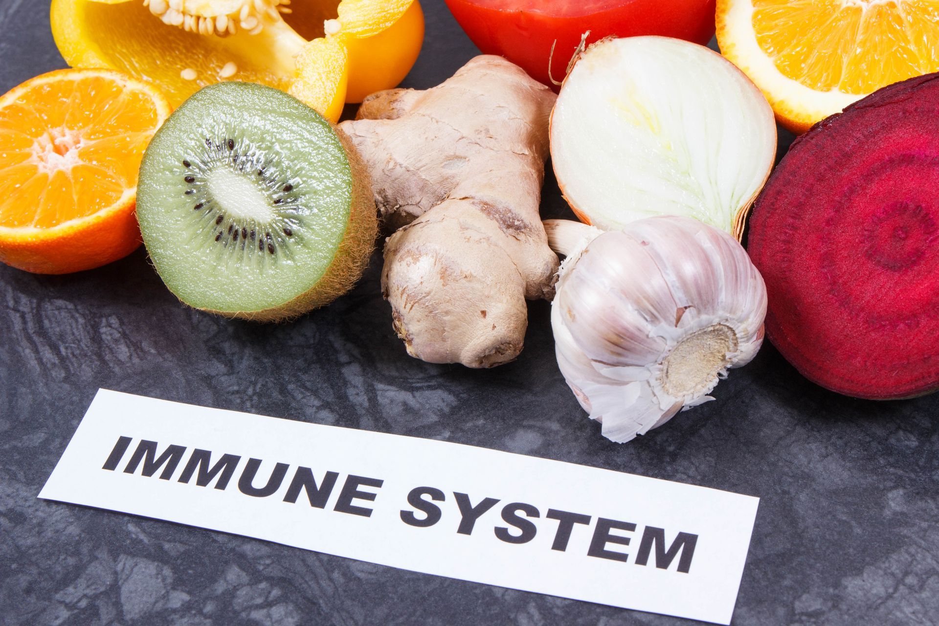 Assortment of fruits and vegetables (kiwi, orange, ginger, garlic, etc.) with a