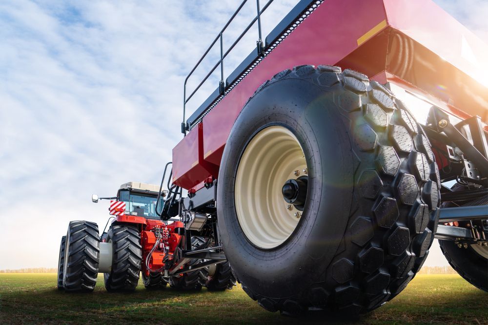 Two tractors are parked next to each other in a field. — Nabiac Mower & Tractor Repairs in Nabiac, NSW