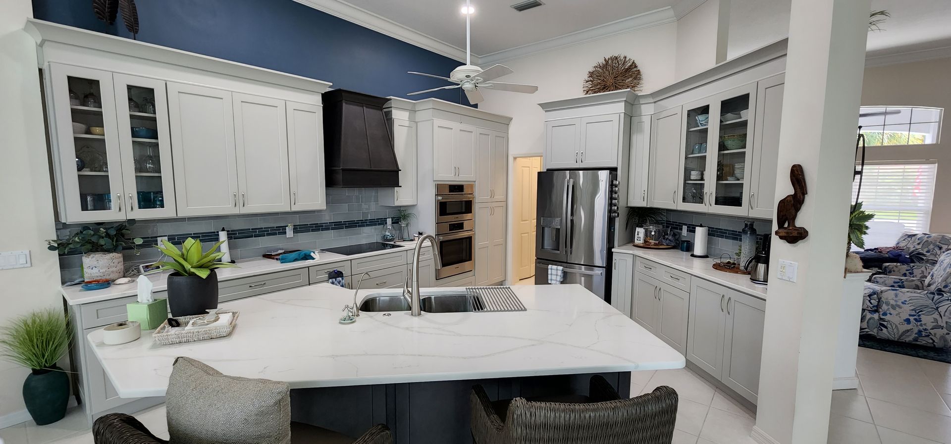 Spacious kitchen with a large island, white cabinets, and stainless steel appliances.