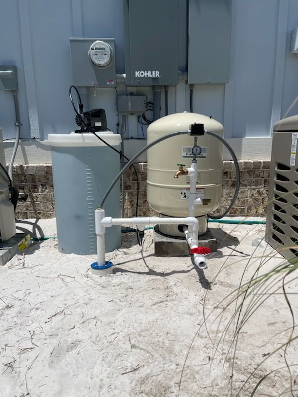 A water tank with a faucet attached to it is sitting on the ground.