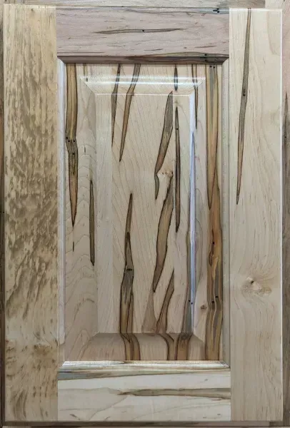 Wooden cabinet door with a raised center panel and visible grain pattern