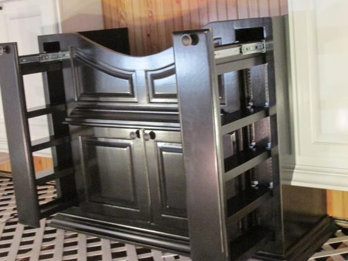 Dark wood cabinet with shelves and paneled doors against a wall