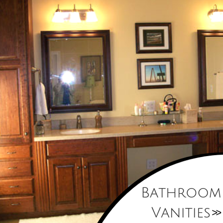 Bathroom vanity with double sinks, wood cabinets, mirrors, and wall art.