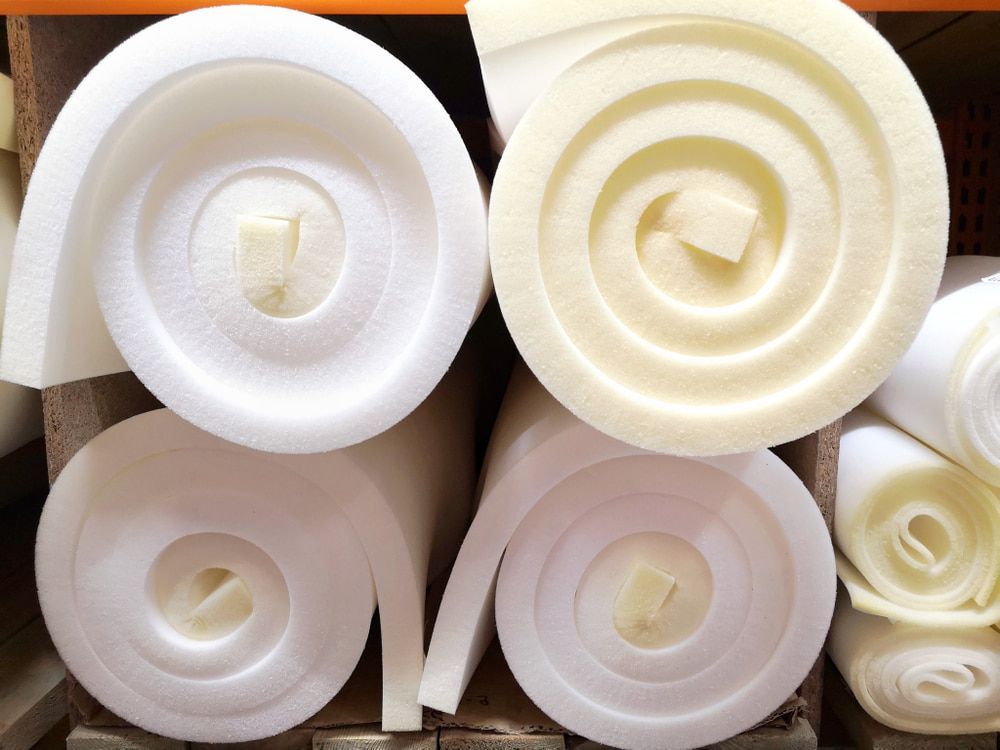Several Rolls Of White Foam Are Stacked On Top Of Each Other — The Woolmen In Ballina, NSW